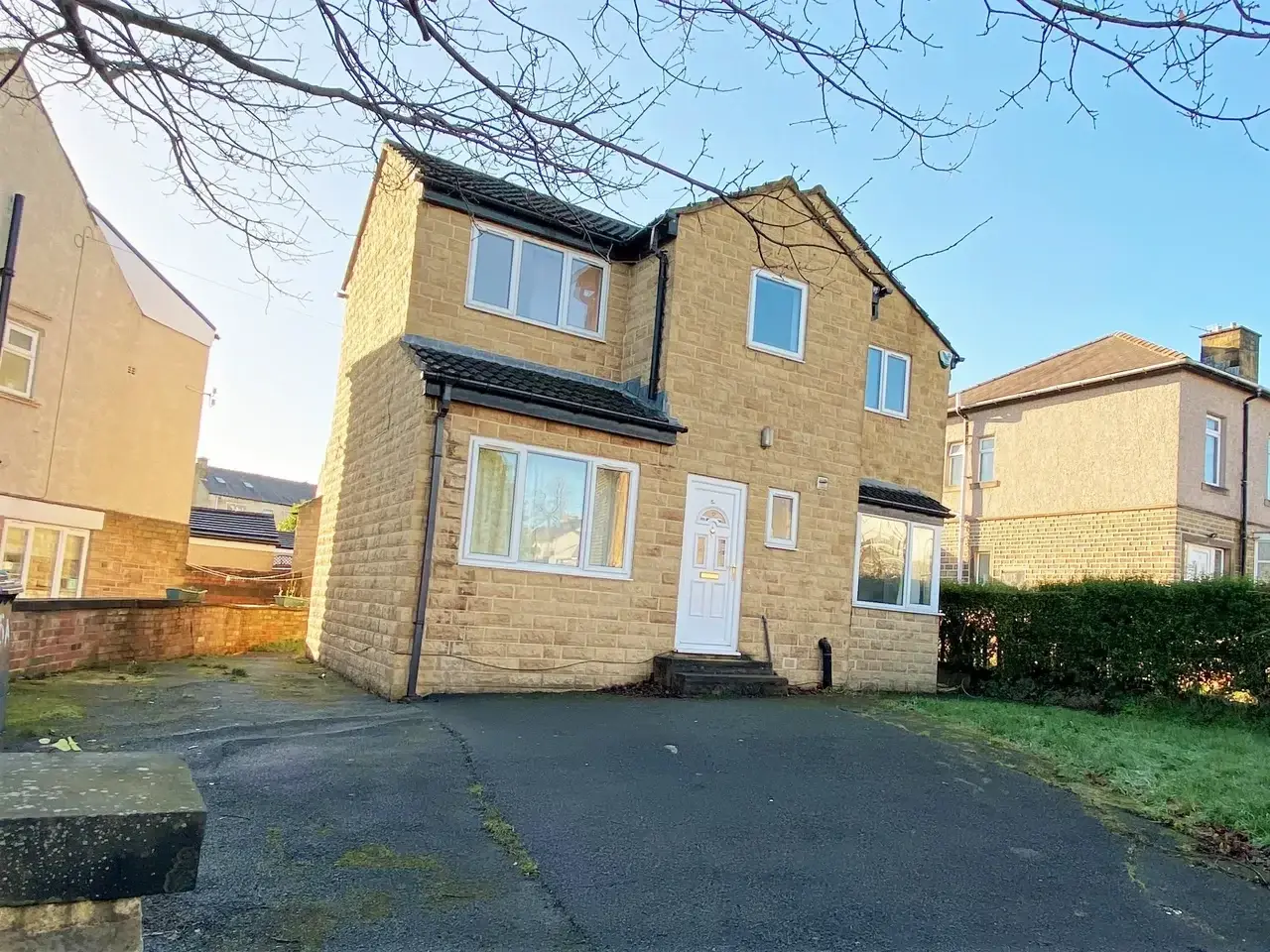 Front exterior and driveway parking at Lynton Avenue 5a, a stone-built house in Huddersfield