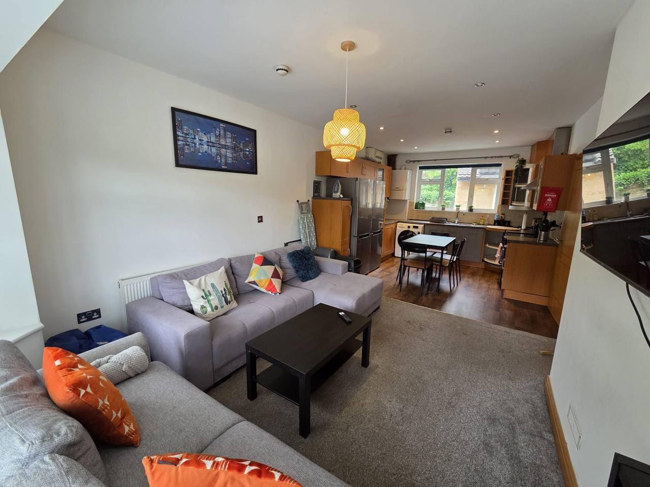 Lounge with corner sofas opening onto the kitchen — Greenhead Road, Huddersfield